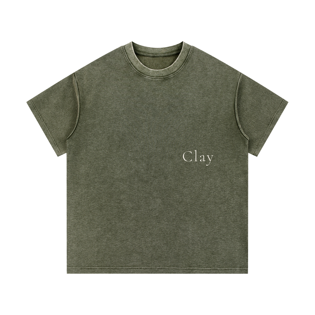 The Greenville Waffle Shirt is an olive green unisex cotton blend tee with "Clay" in small white serif font on the left chest. It features short sleeves and a crew neckline for a relaxed, streetwear-inspired look.