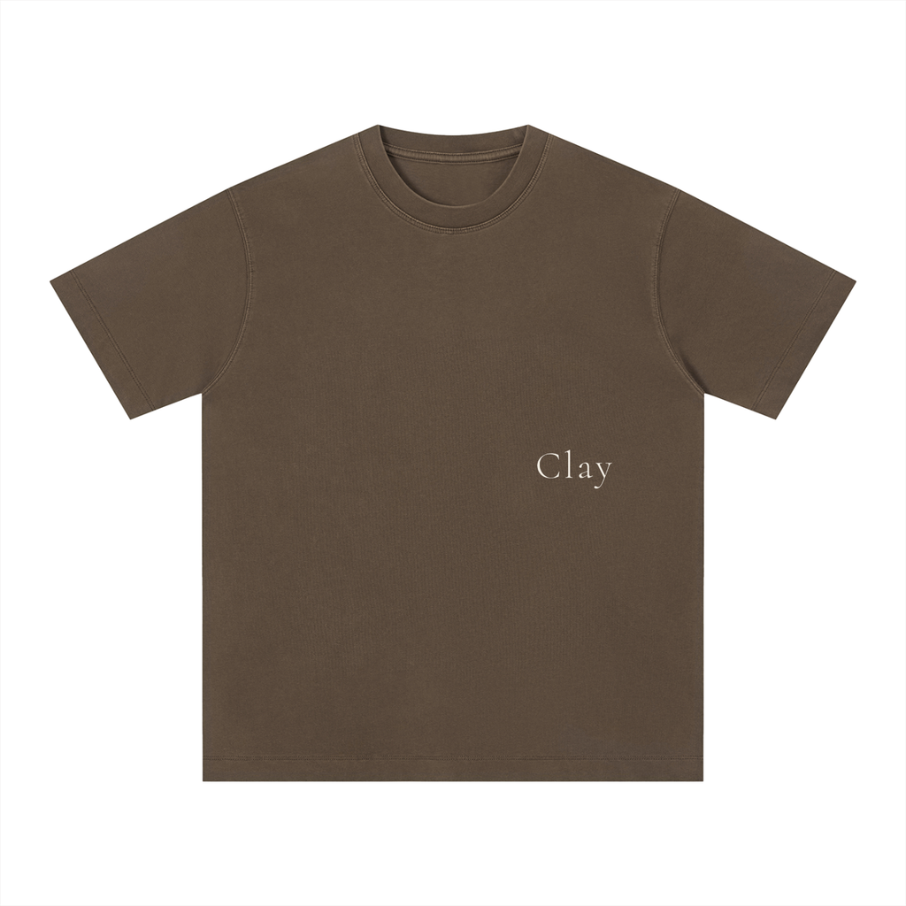 The Charleston Shirt is a loose fit unisex brown cotton t-shirt with "Clay" printed in small, light text on the left chest. This short sleeve tee is shown on a white background.