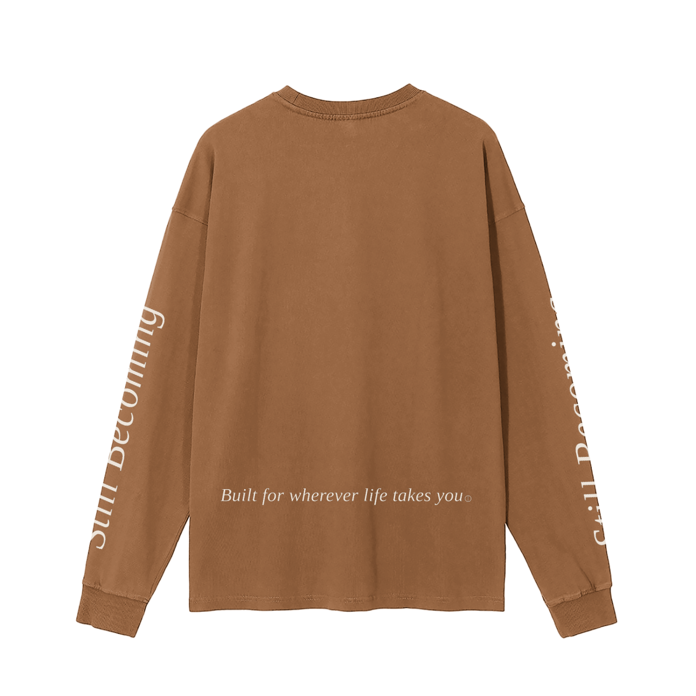 The Gatlinburg Long Sleeve T-Shirt is a brown unisex cotton top with "Built for wherever life takes you" on the lower back and "still becoming" in white on both sleeves—a stylish streetwear choice for autumn and winter.