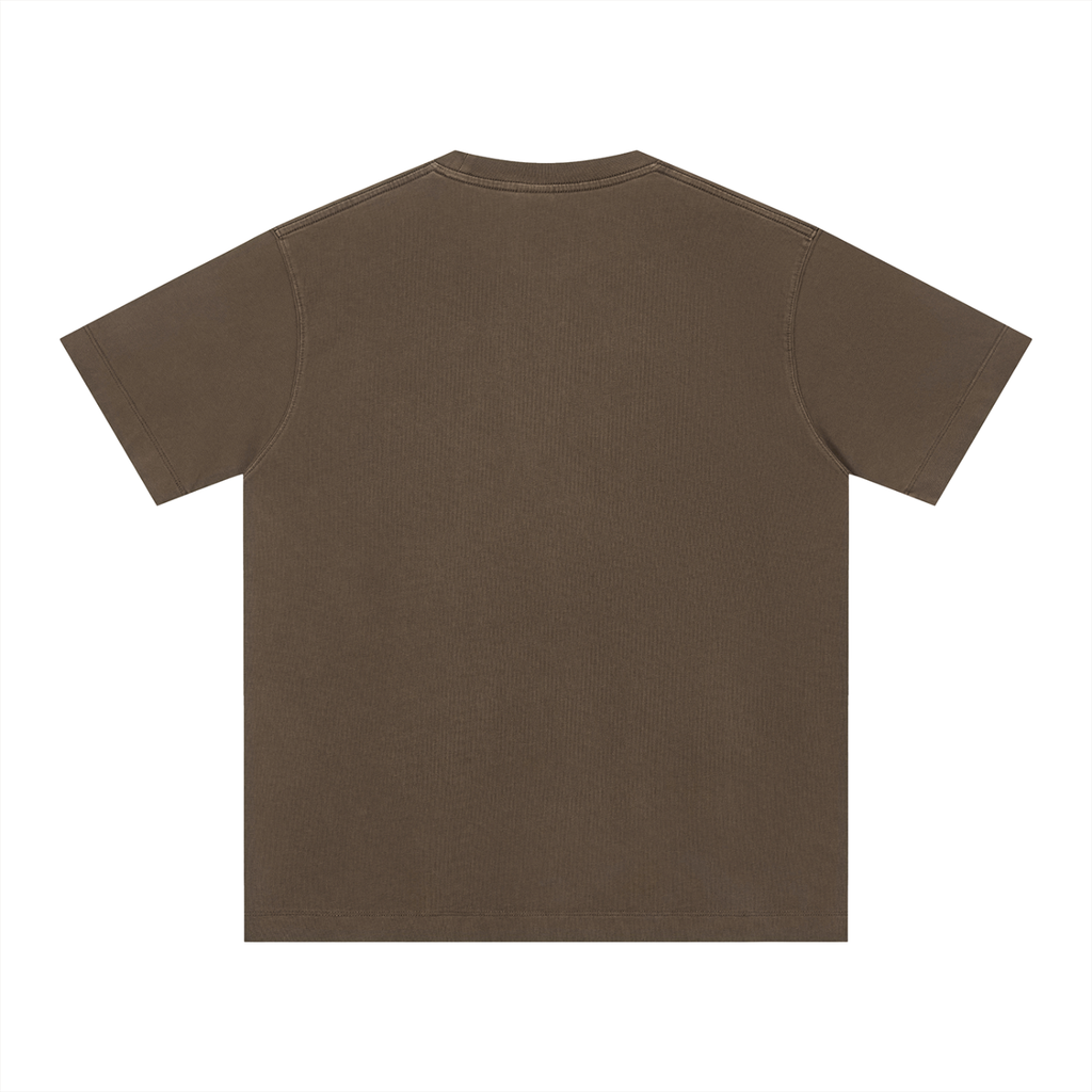 The Charleston Shirt, a plain brown unisex cotton t-shirt with a classic crew neck and loose fit, is shown laid flat with the back facing up on a white background. The short sleeve shirt has no visible designs or logos.