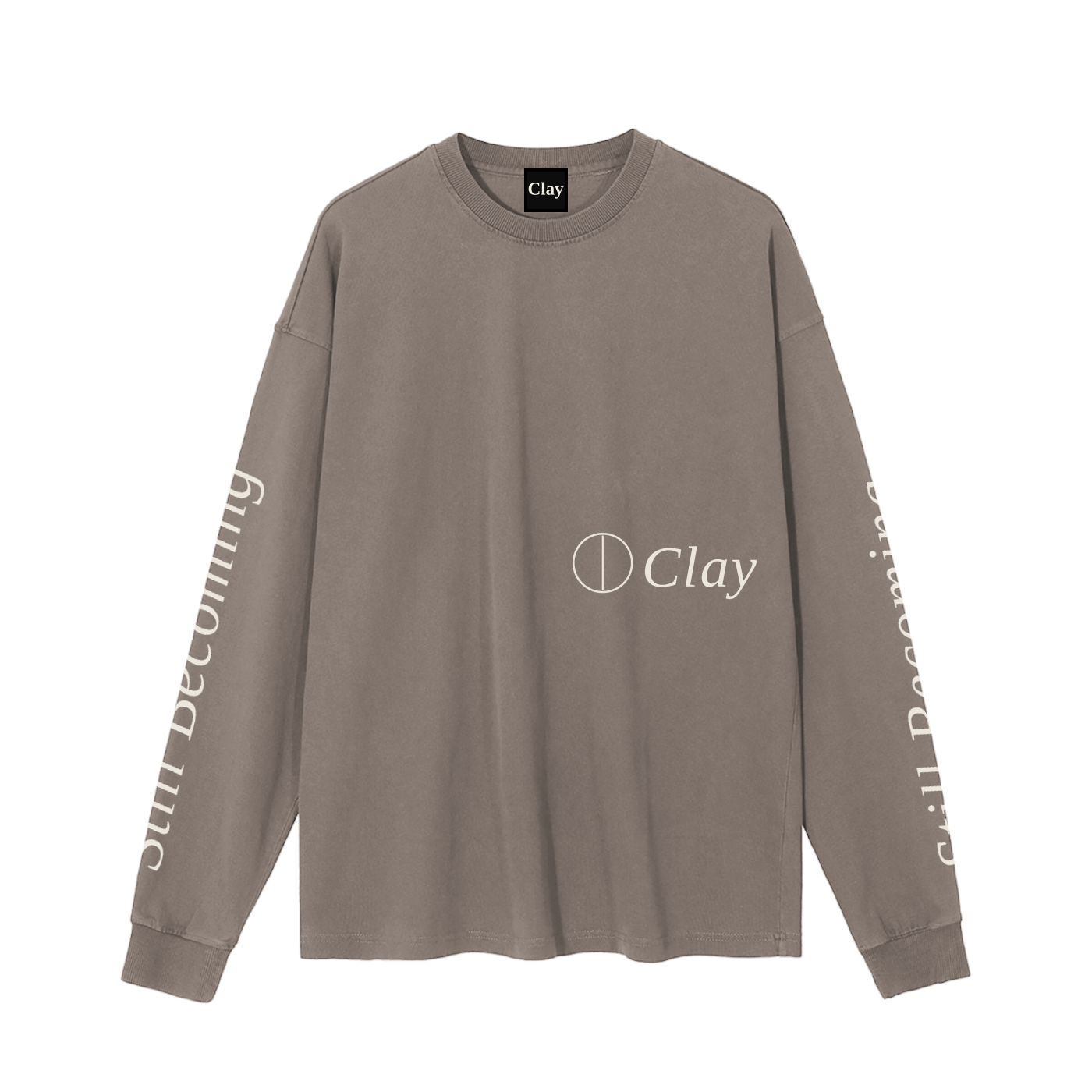 The Gatlinburg Long Sleeve T-Shirt is a unisex taupe cotton sweatshirt with Clay and a circular logo on the front, plus “Still Becoming” in white down both sleeves—a street casual essential.