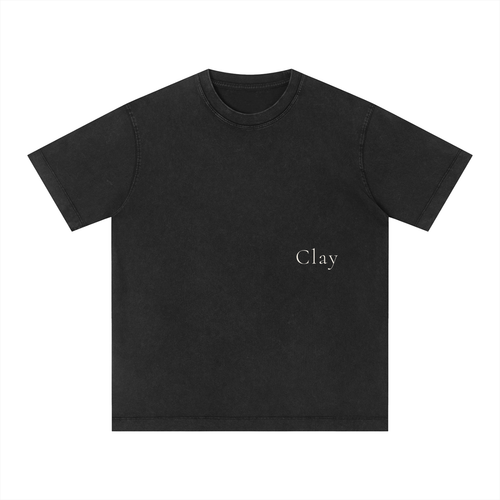 The Charleston Shirt is a loose-fit unisex cotton tee in plain black with short sleeves, featuring "Clay" in small, simple white text on the left chest.