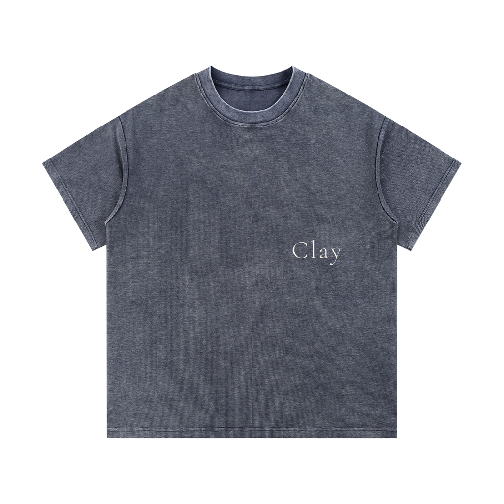 The Greenville Waffle Shirt is a unisex cotton blend streetwear essential in dark gray with "Clay" printed in small white letters on the left chest. Its loose fit and airy summer style deliver effortless, everyday comfort.