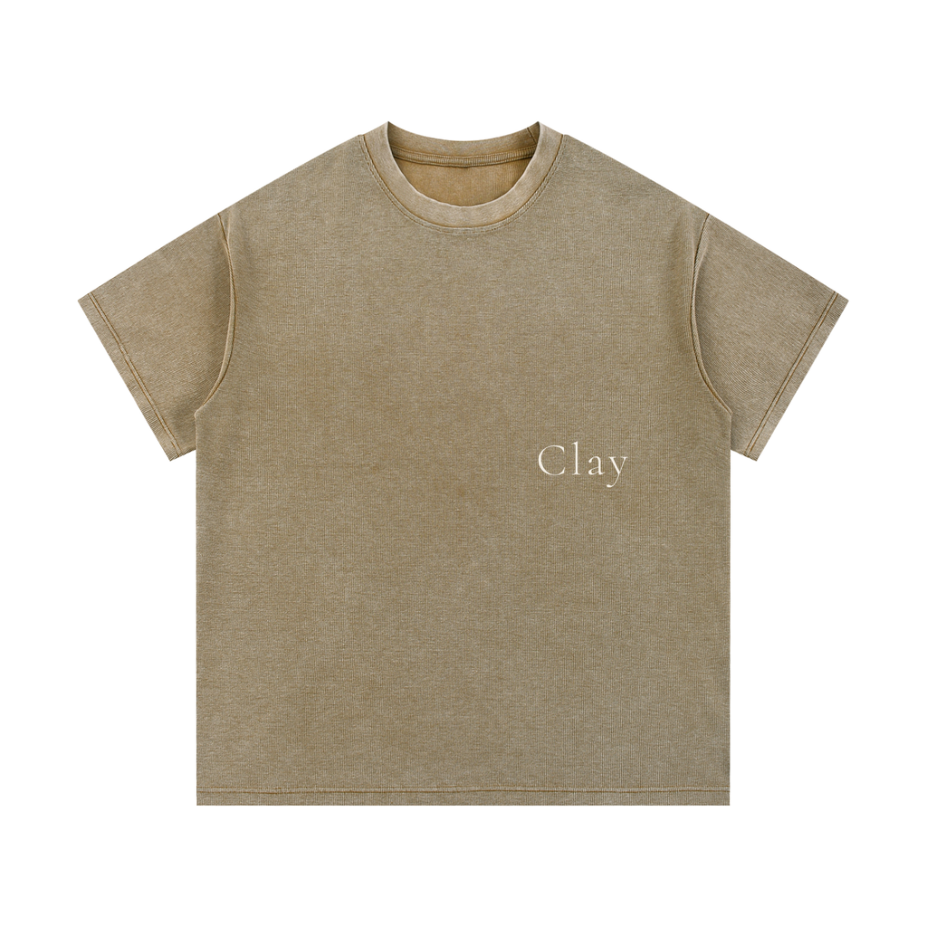The Greenville Waffle Shirt is a light brown unisex cotton-blend tee with "Clay" in small white print on the left chest. It has a loose fit, short sleeves, and a crew neck—ideal for casual summer streetwear.