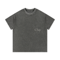 The Greenville Waffle Shirt is a loose-fit unisex cotton blend t-shirt in faded black, featuring short sleeves and "Clay" printed in small white letters on the left chest—ideal for casual summer streetwear.