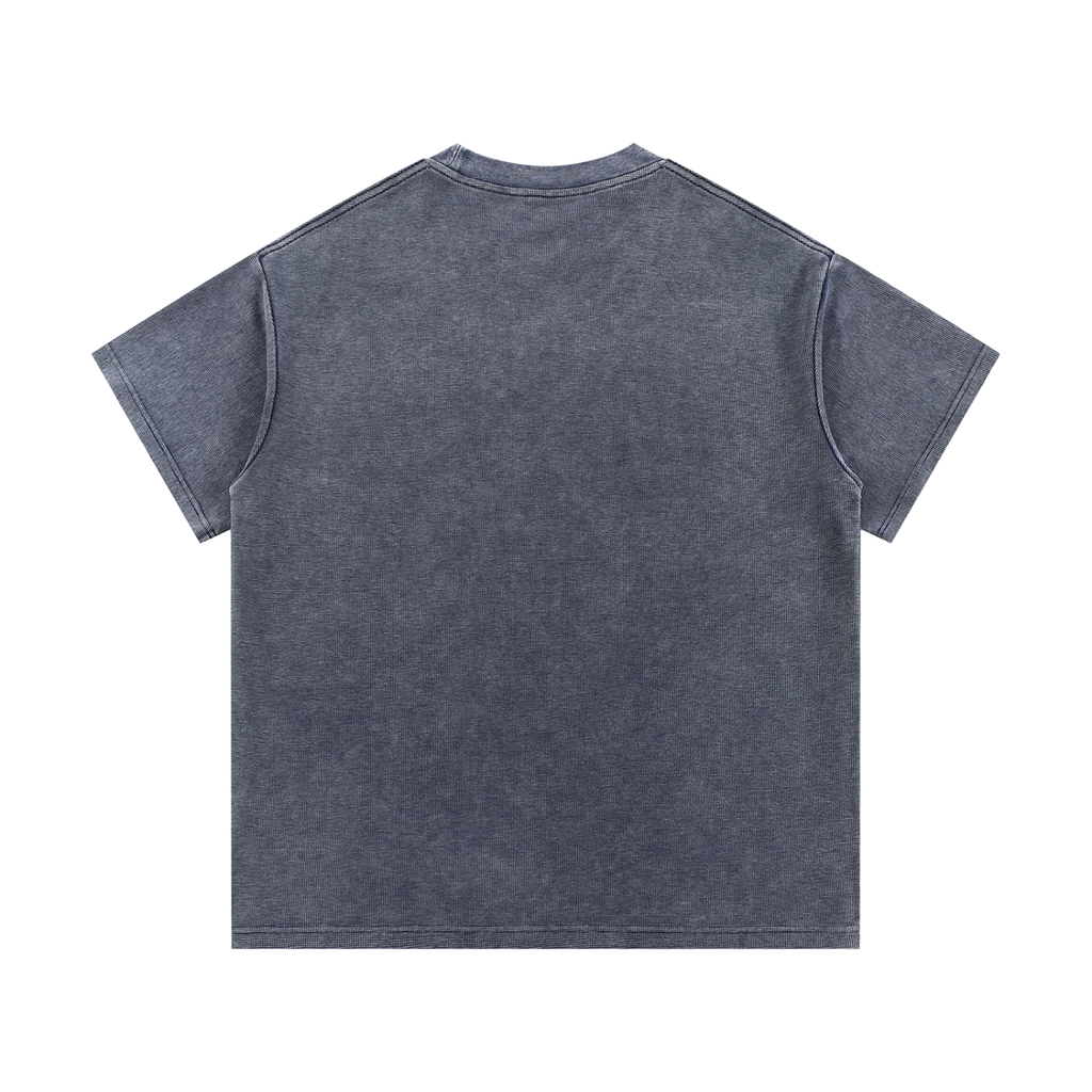 The Greenville Waffle Shirt is a unisex, short-sleeved crew neck tee in washed dark gray cotton blend, shown flat with the back up. Its visible seam stitching and relaxed, boxy fit make it a perfect loose summer streetwear staple.