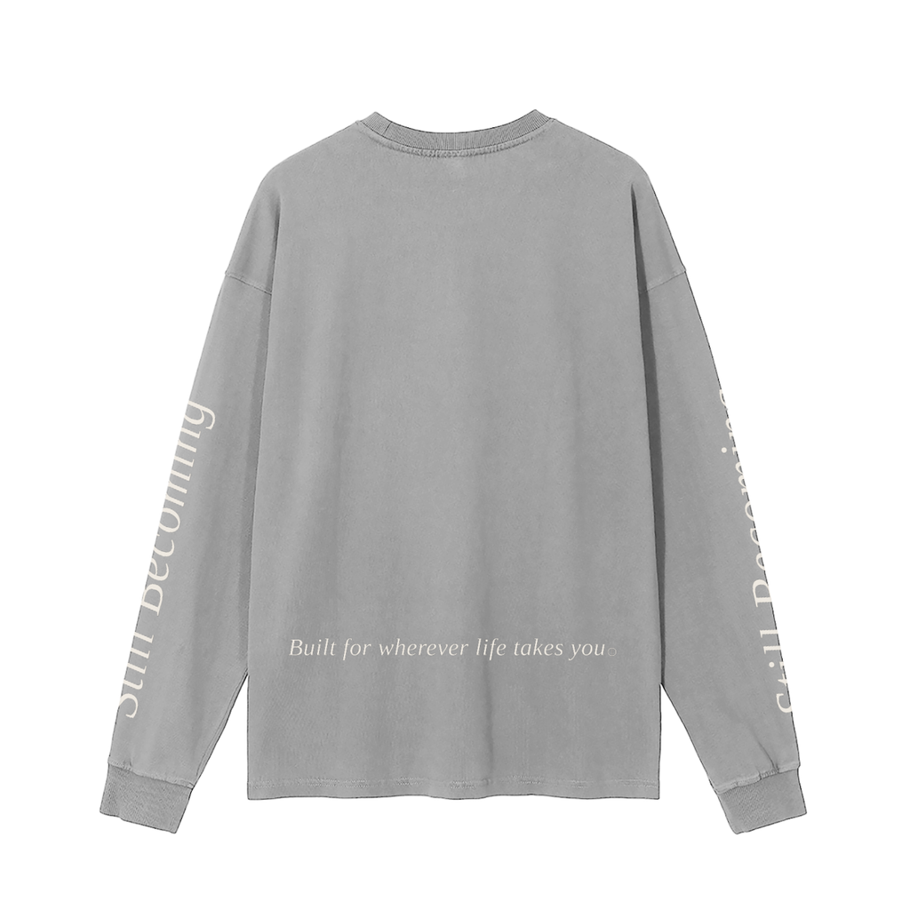 The Gatlinburg Long Sleeve T-Shirt is a gray unisex cotton top with white text on the sleeves and lower back reading, "Built for wherever life takes you"—the perfect casual streetwear choice for autumn and winter.